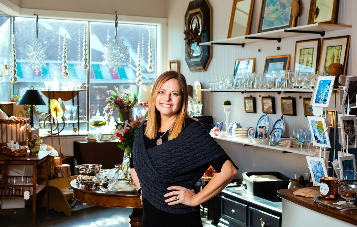 Barbara Konsin in her home decor store, in front of the window