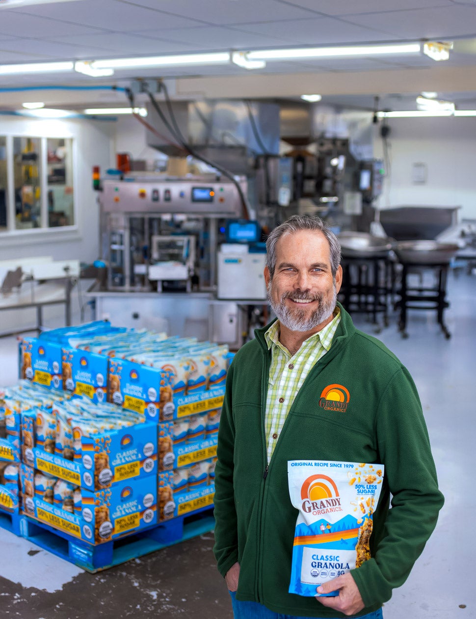 Man holding food product in a factory.