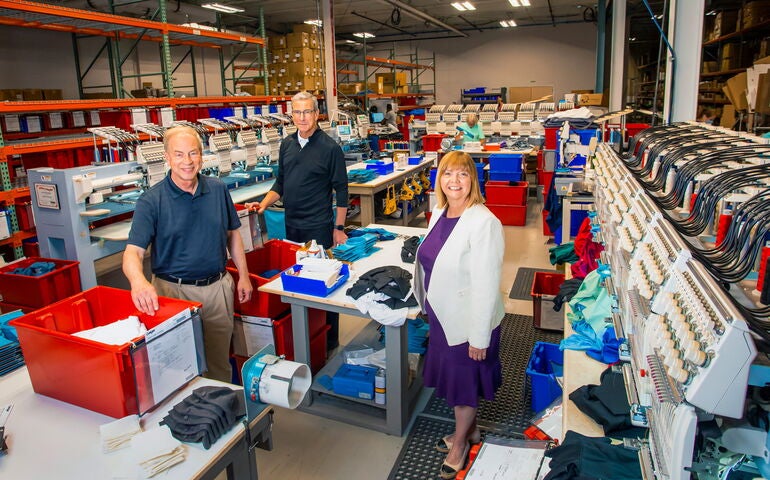 Geiger factory shot of 3 executives.