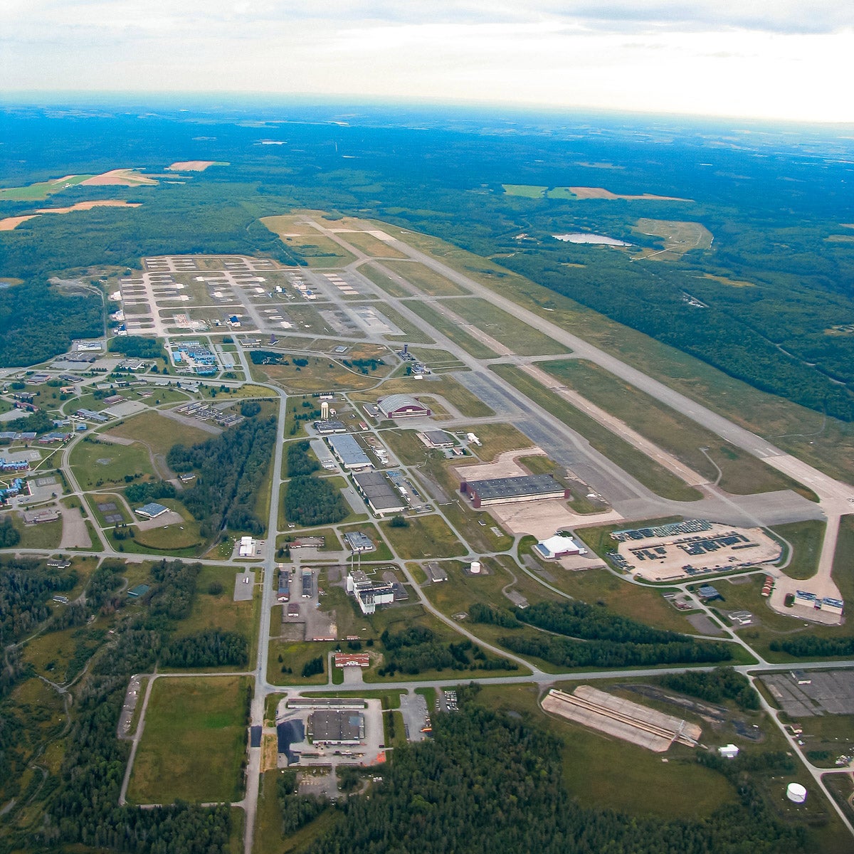 Aerial view of former Loring Air Force base showing runways, buildings, etc.