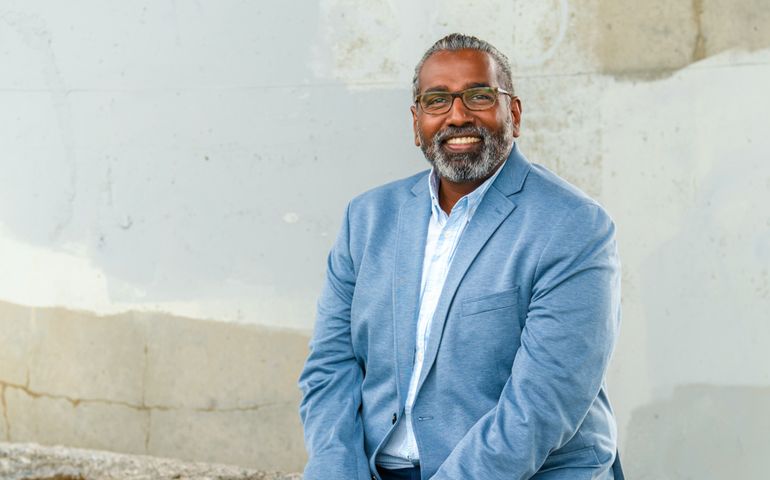Noel Bonam seated outdoors