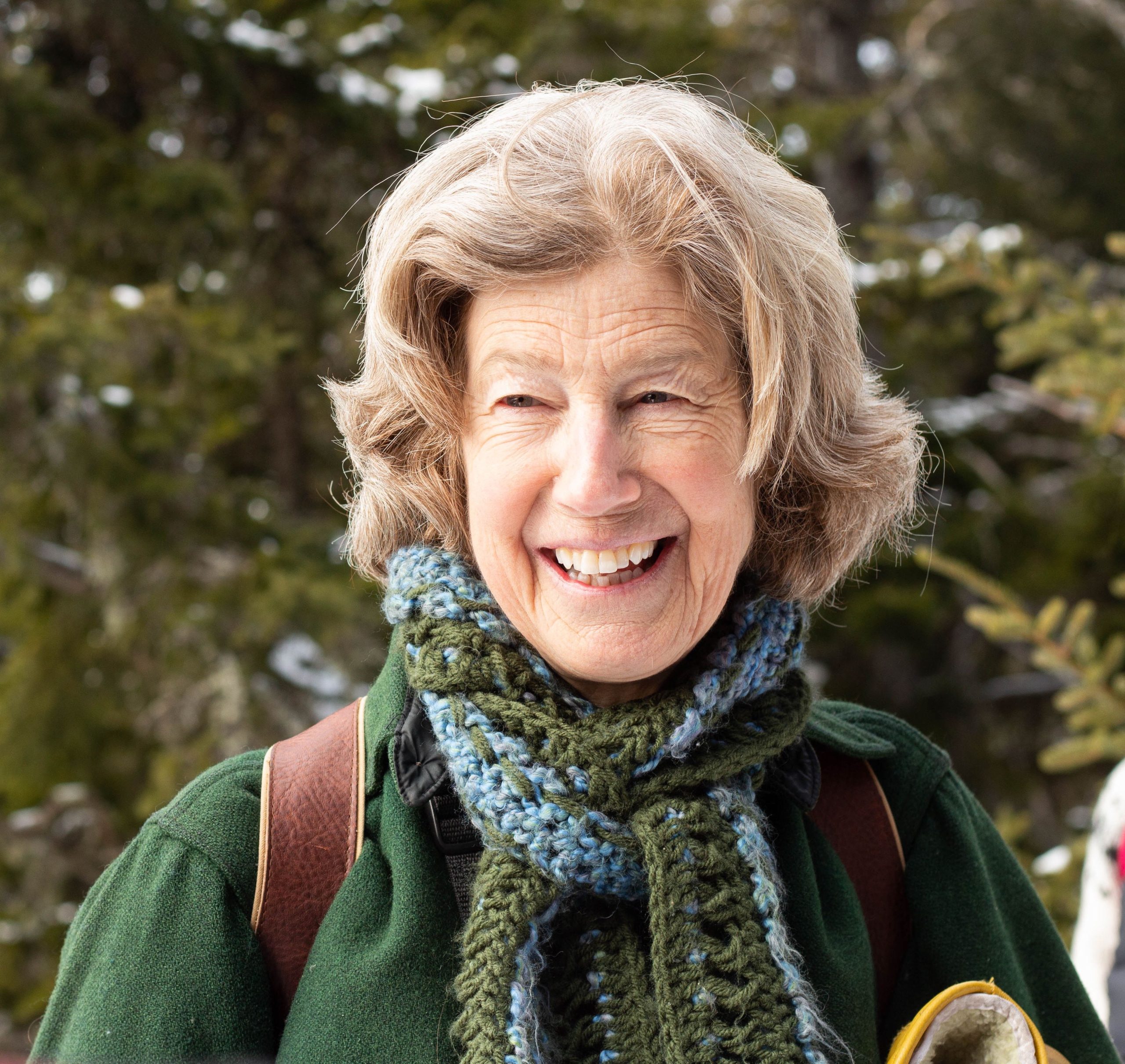 person with scarf smiling