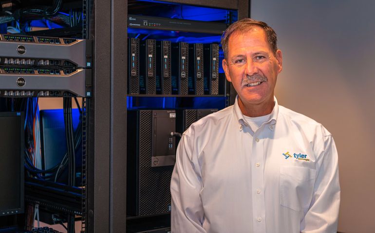 man standing in front of computer servers