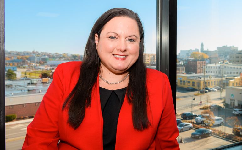 Portrait of Michelle Accardi in her office, in front of a window.