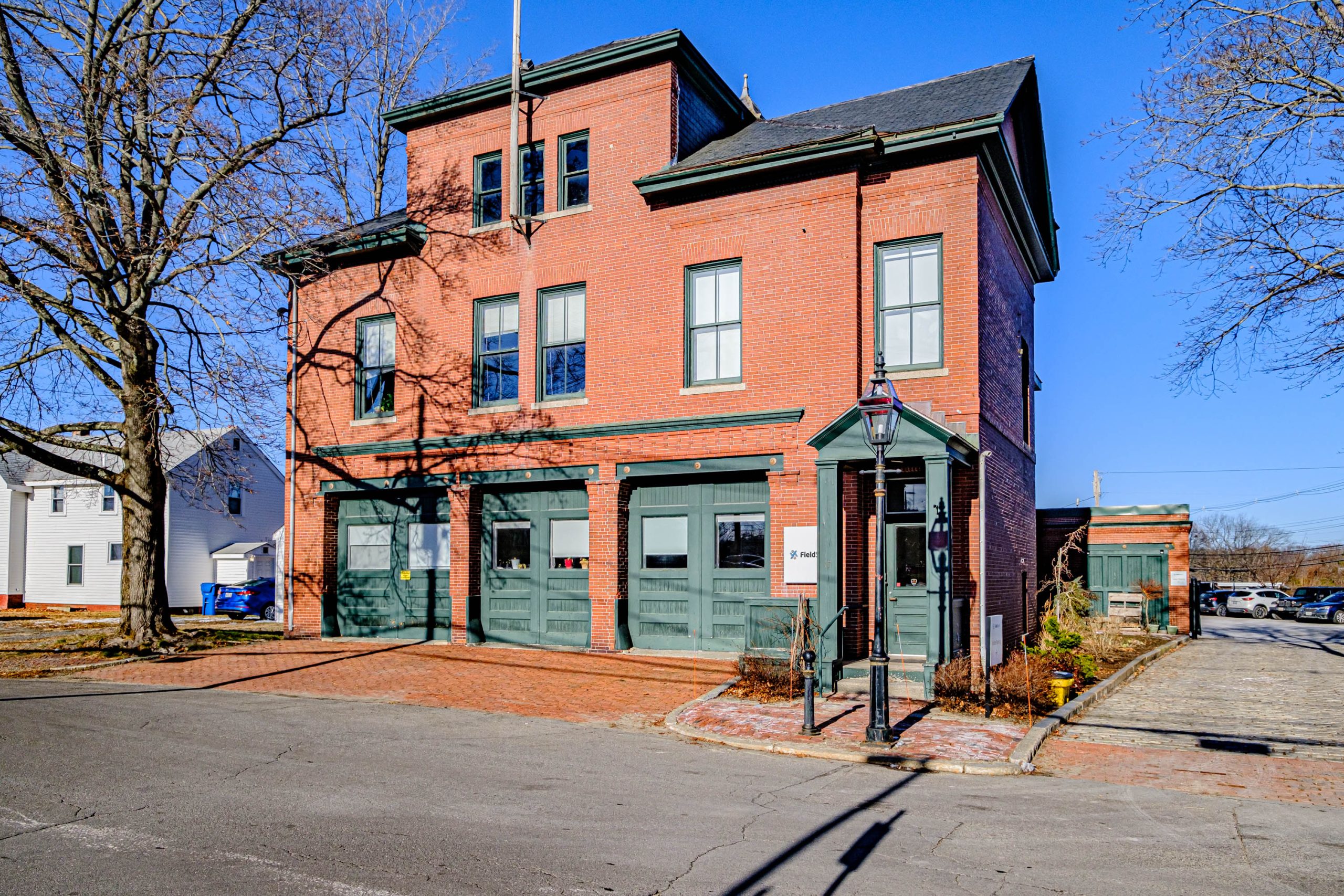 brick building with large green doors