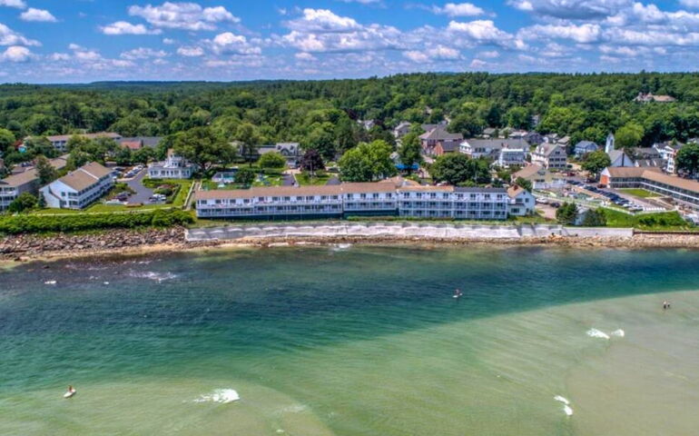 An aerial view of a hotel and oceanfront.