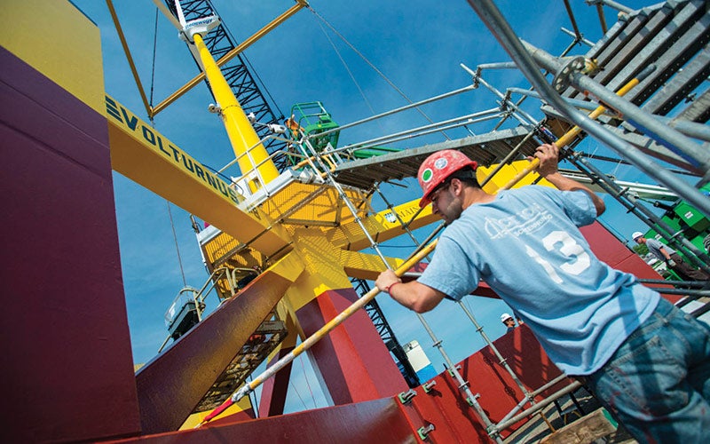 Worker checking on a prototype offshore wind platform.
