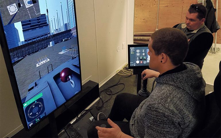 Two men looking at  computer screen