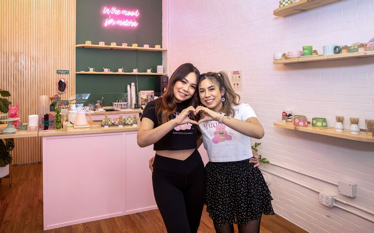 2 people hugging and making heart sign with hands