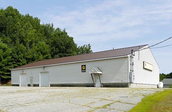 A building has a parking lot.
