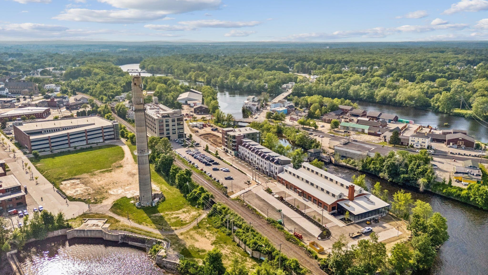 An aerial view looks down on a building and a parking lot.