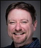 A person poses for a headshot.