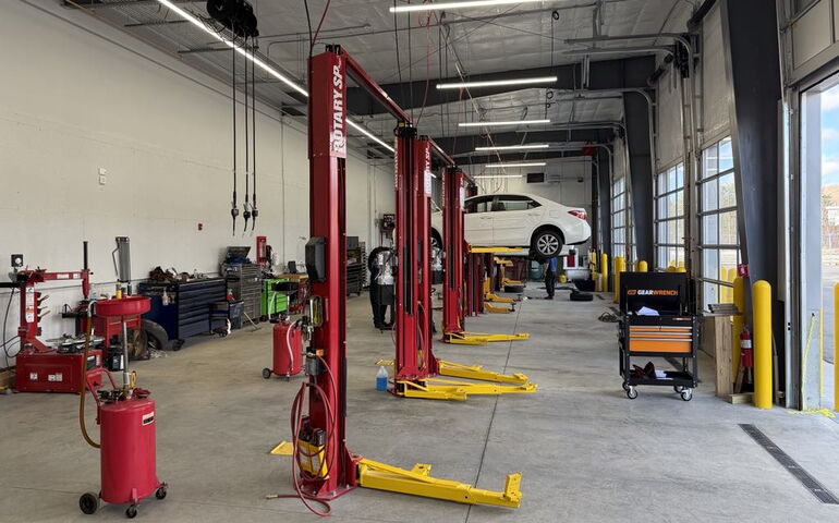 A garge interior includes lifts and equipment.