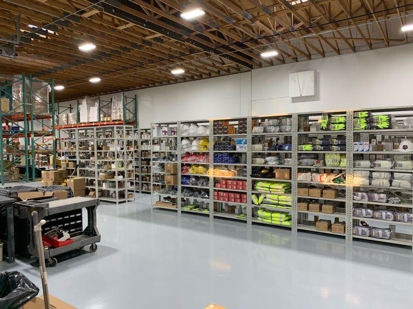 A warehouse has lots of shelves loaded with supplies.
