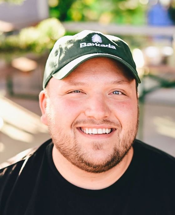 A person poses for a headshot.