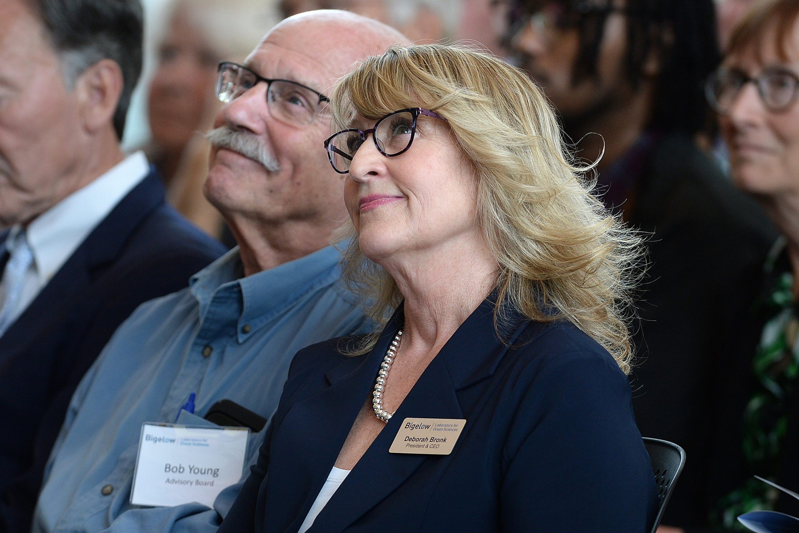 Two people look upward.