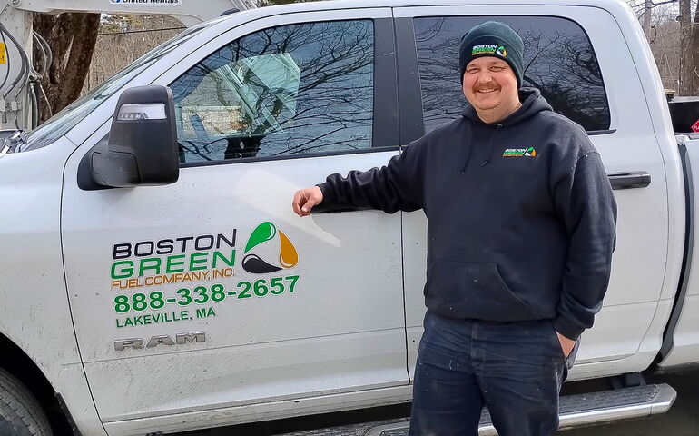 A person stands outside of a truck.