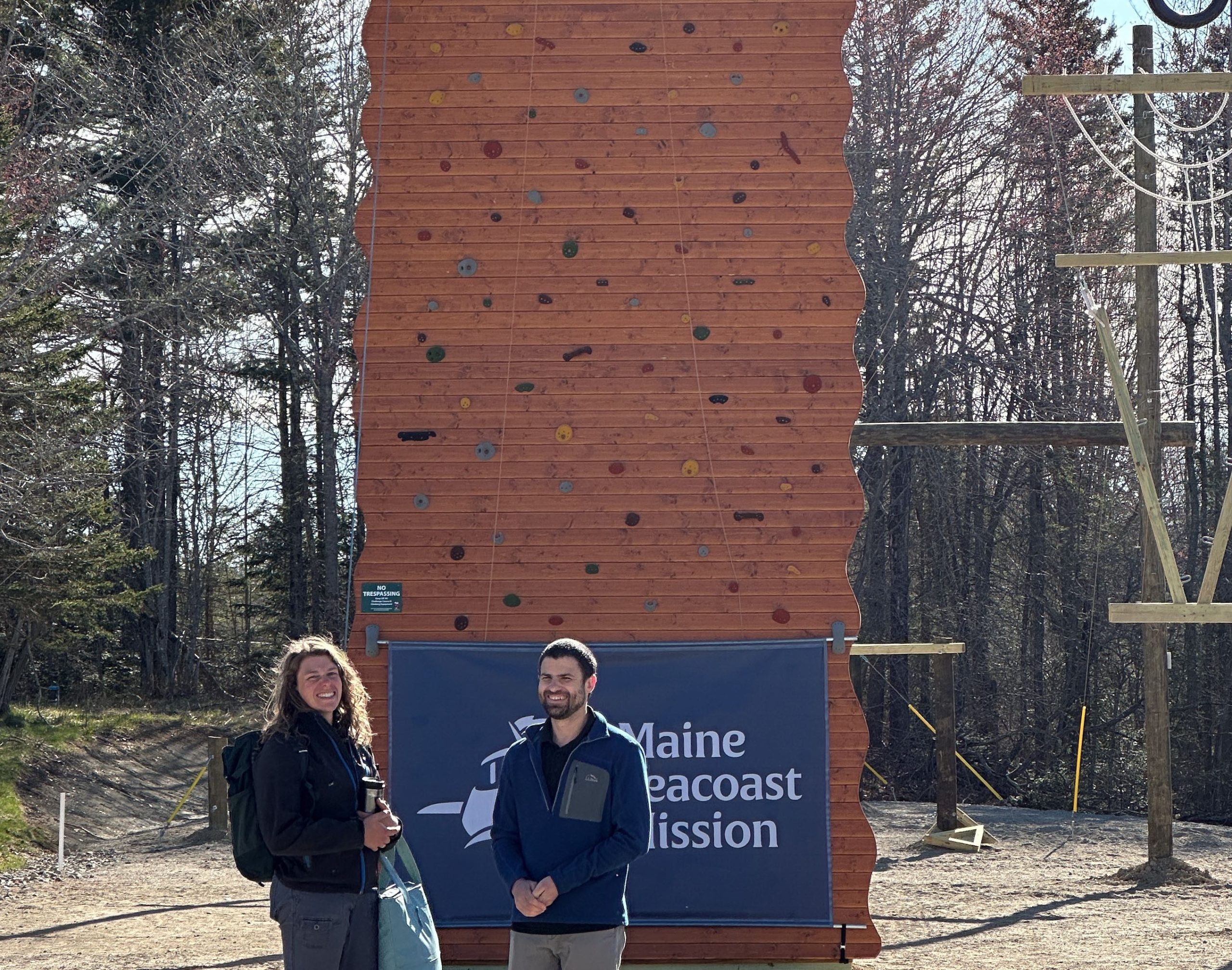 two people in front of partial wall