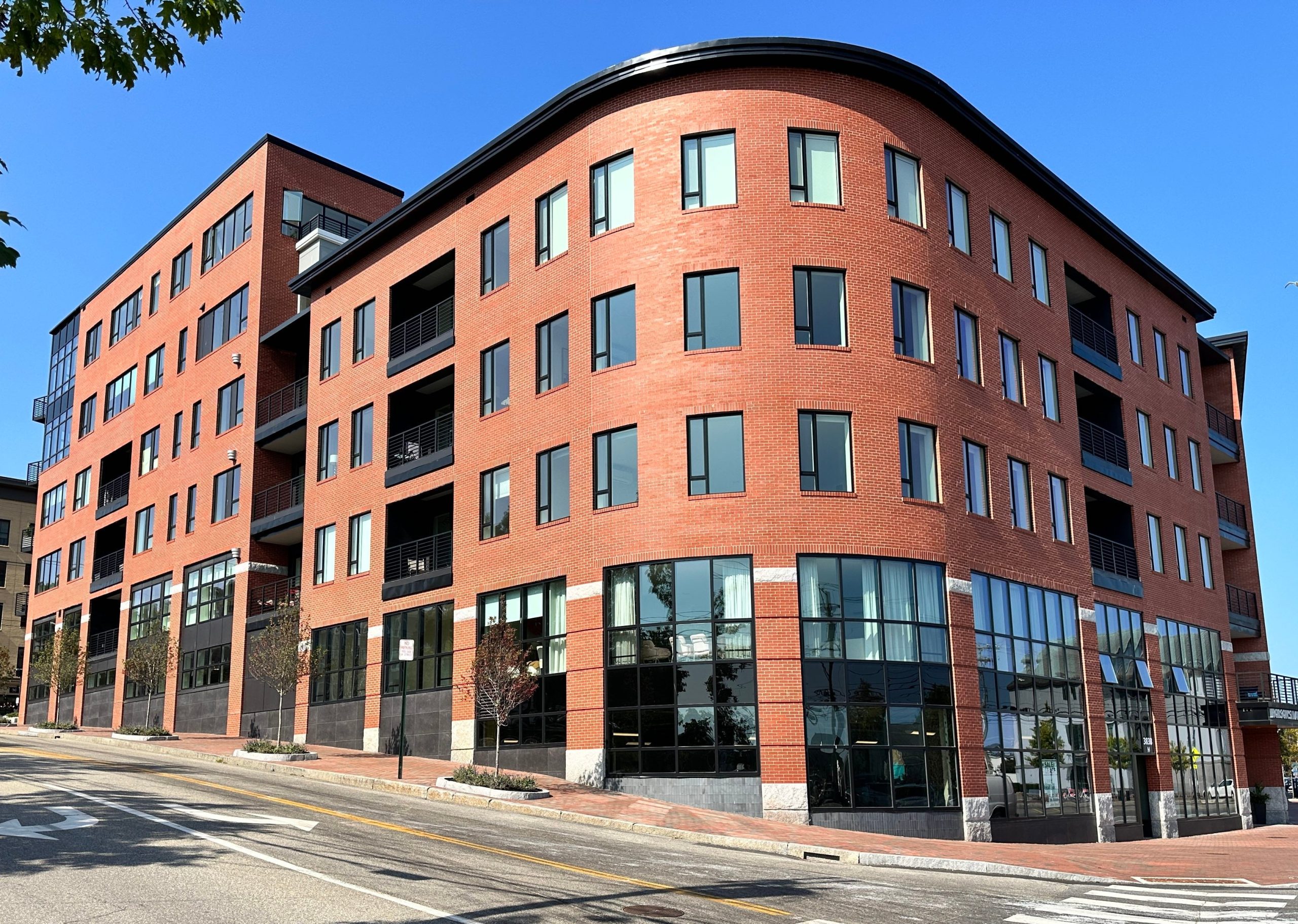 A brick building has a rounded corner.