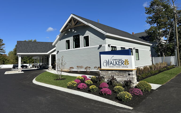 An exterior view of a building and flowers.