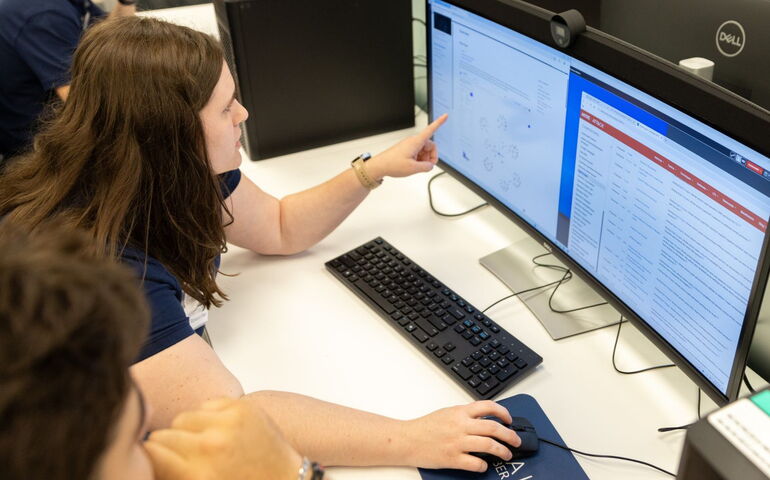 People look at a computer screen.