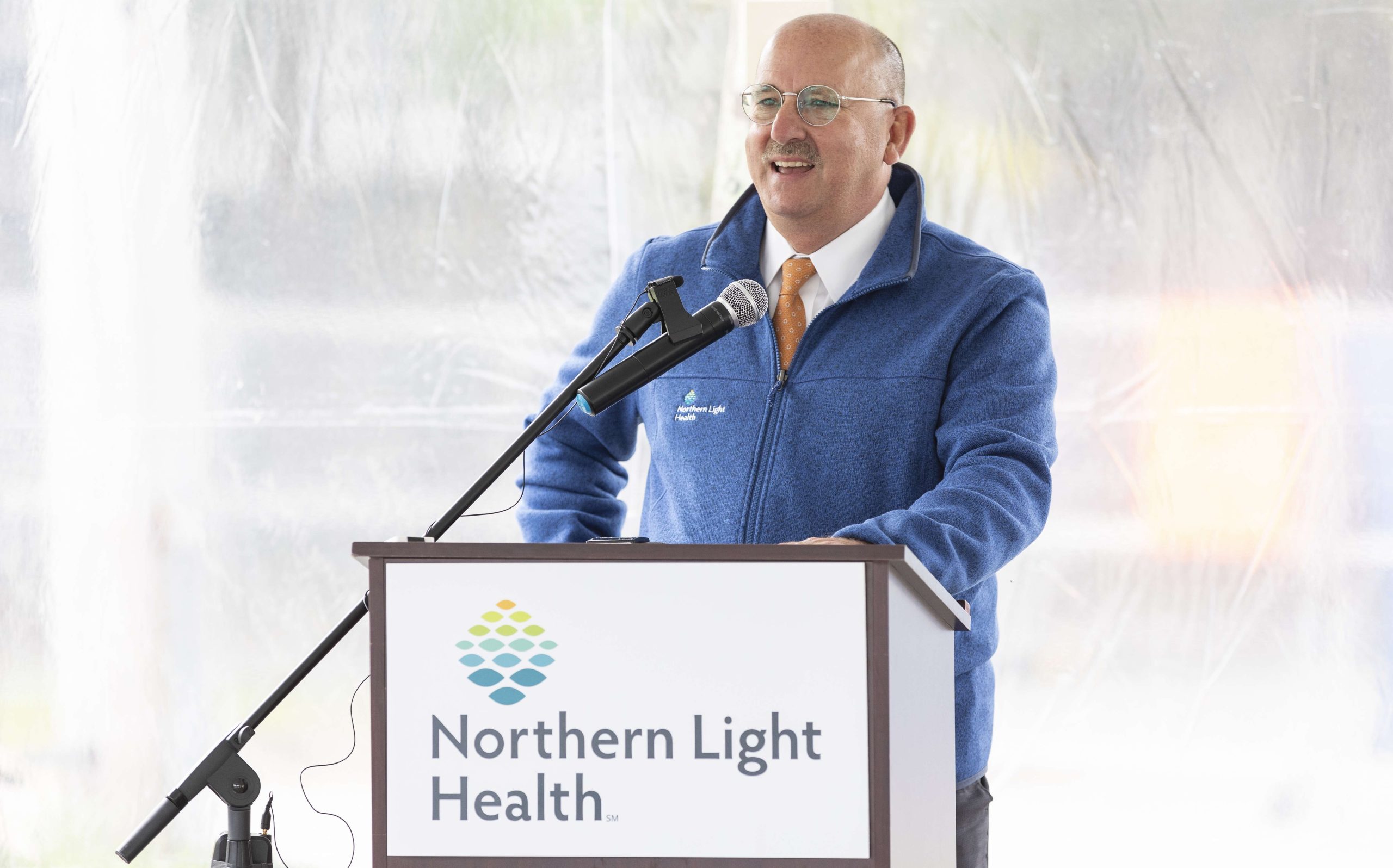 A person speaks at a podium.