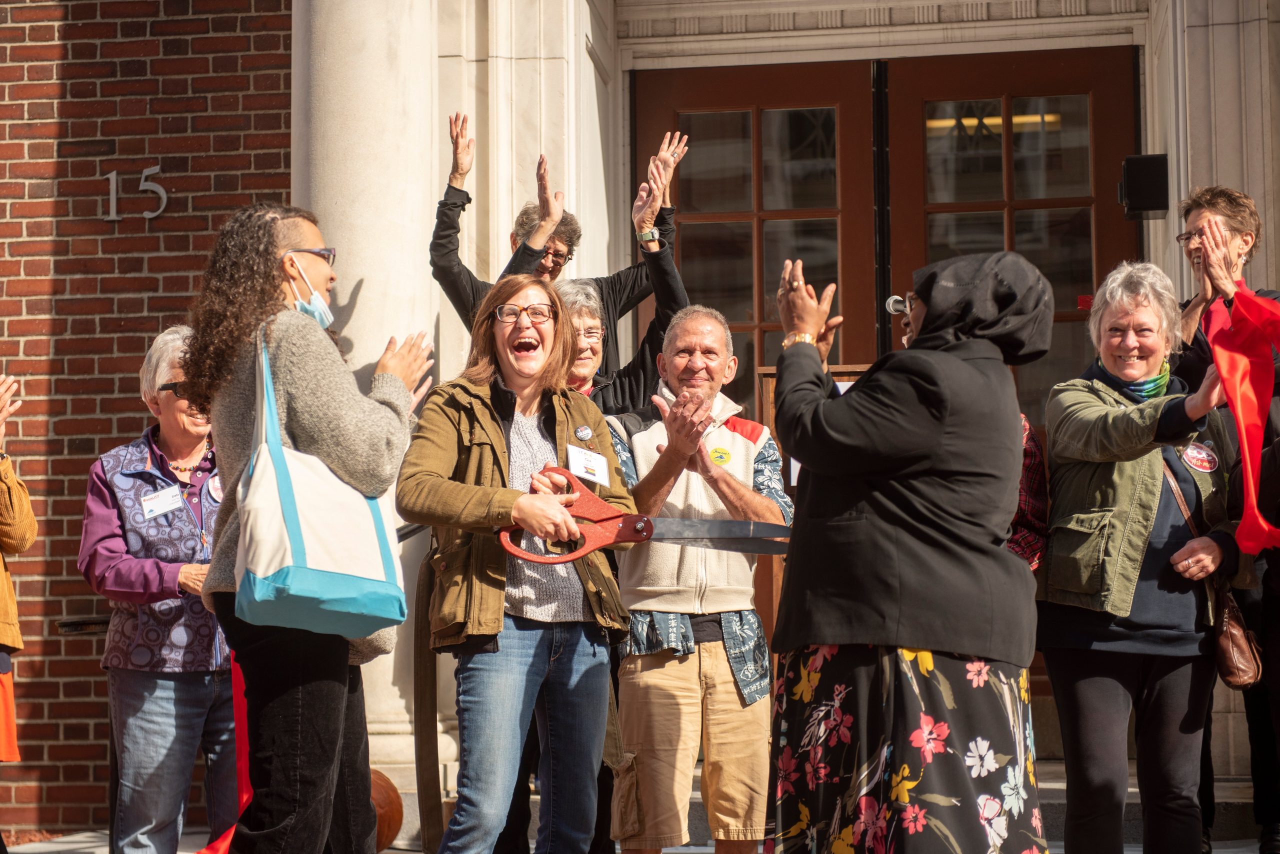 People cheer in front of the Equality Community Center