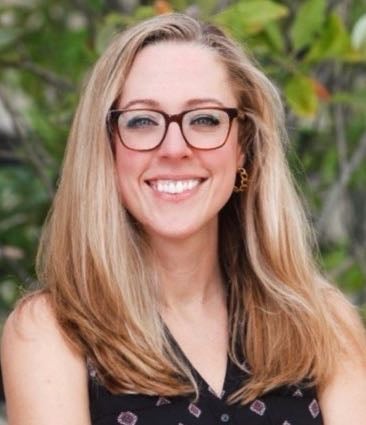 person with long hair and sleeveless shirt