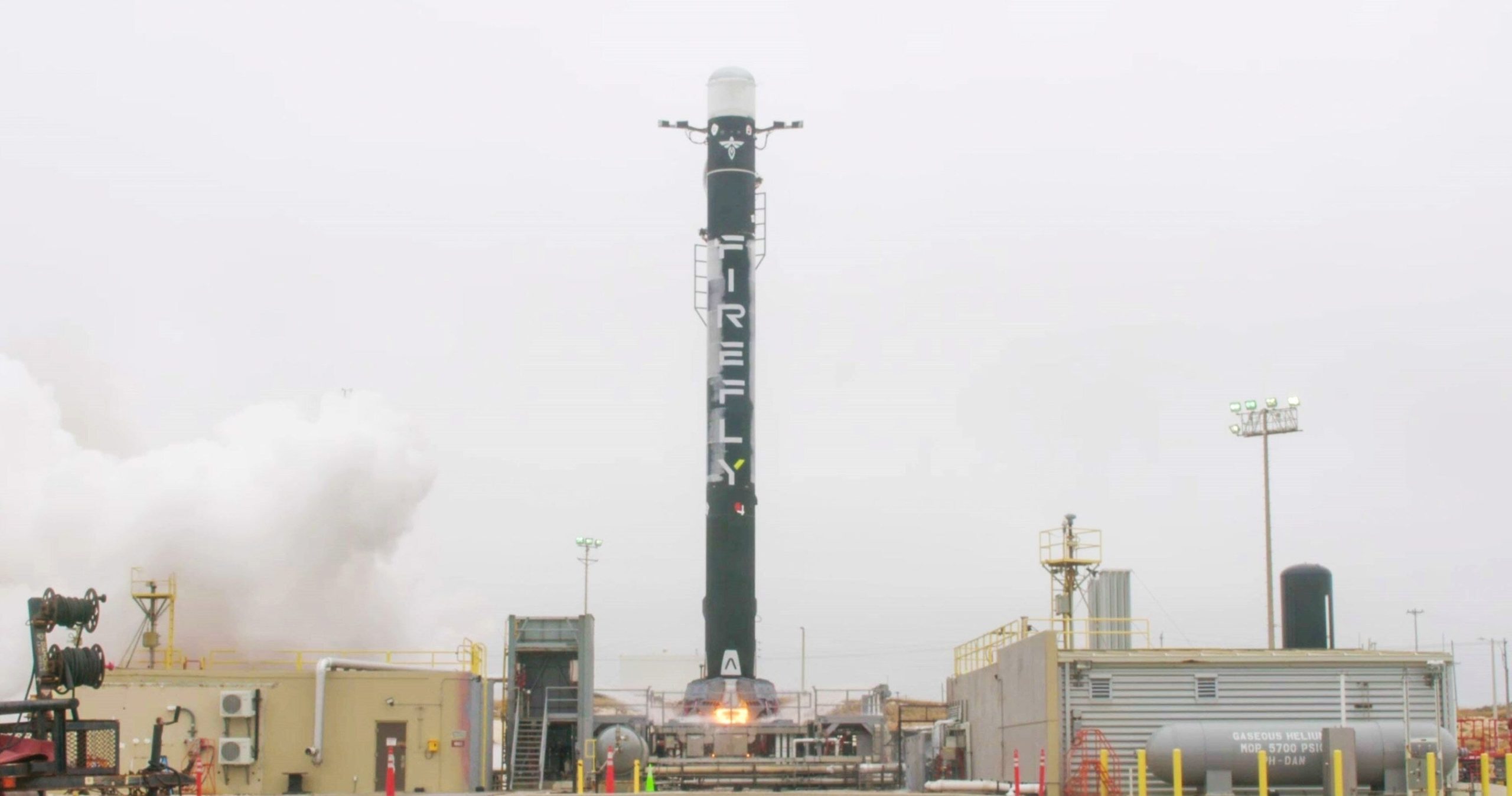 A rocket has the launch fire going underneath it.
