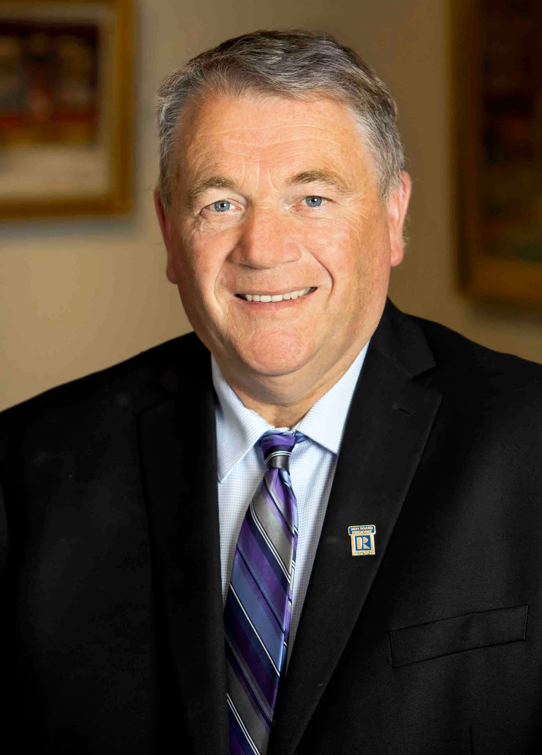 A person poses for a headshot.