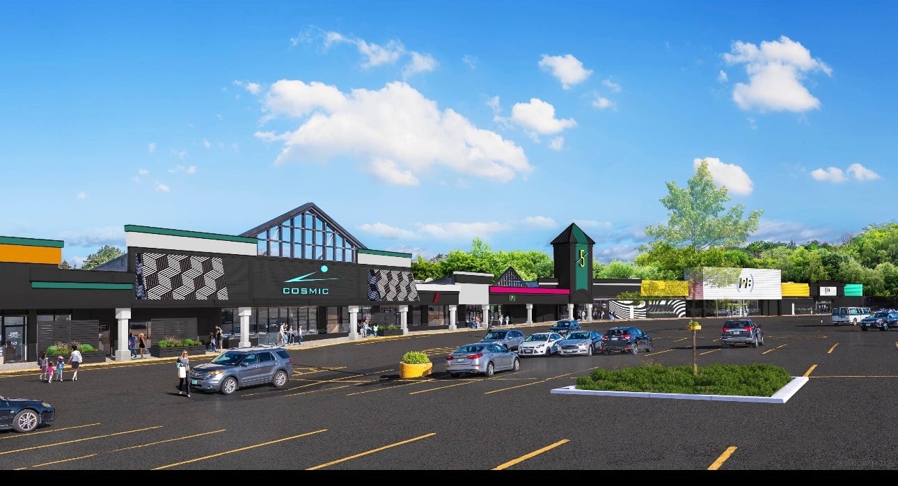 rendering of long low building and parking lot and cars