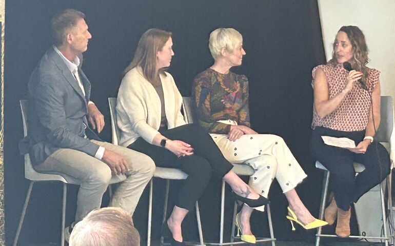 Four people seated on stage