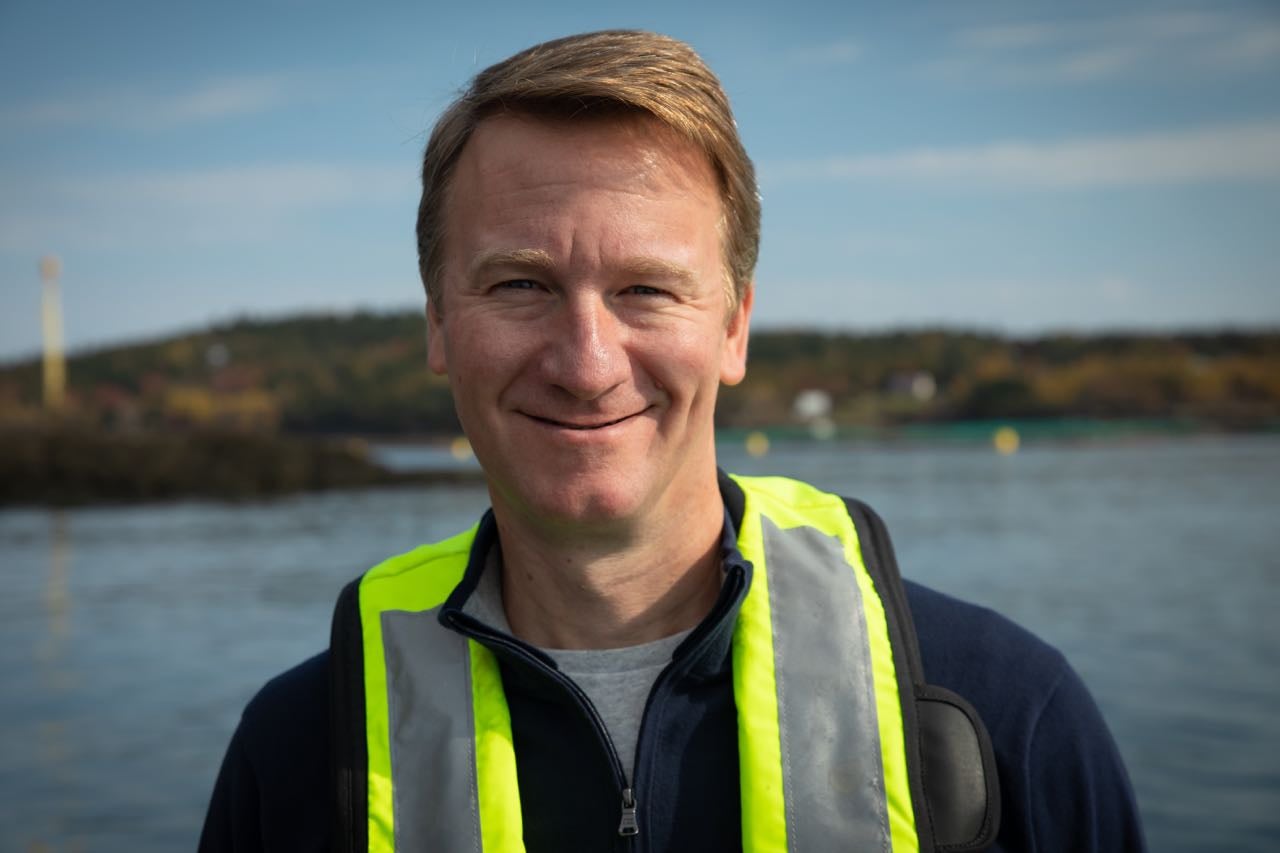 Joel Richardson stands by the water.