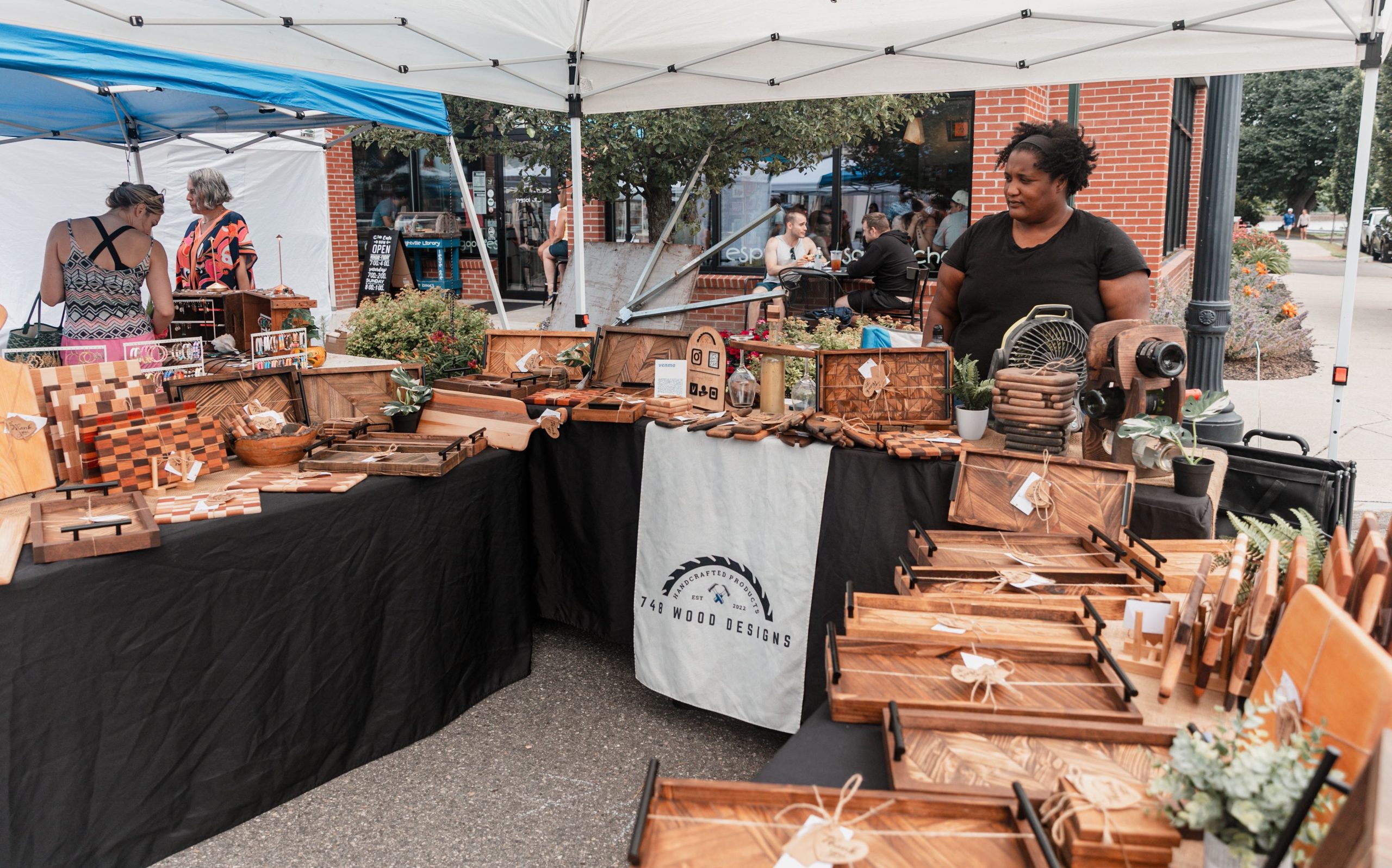 Tables are set up with wooden items.