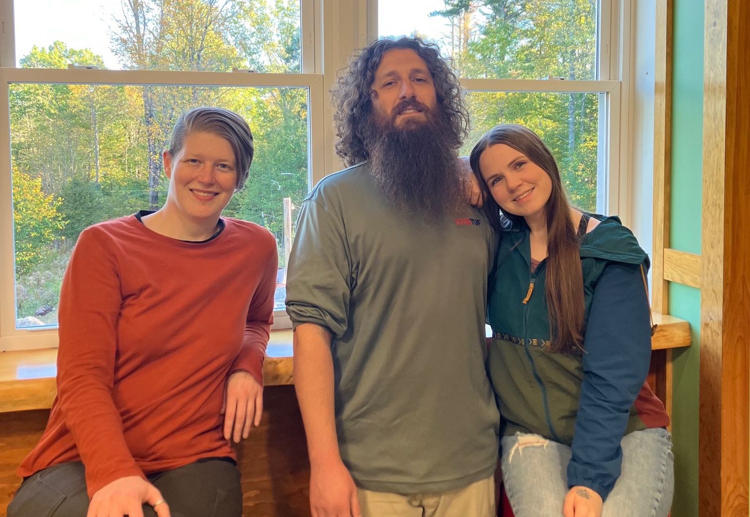 Three people pose for a photo.