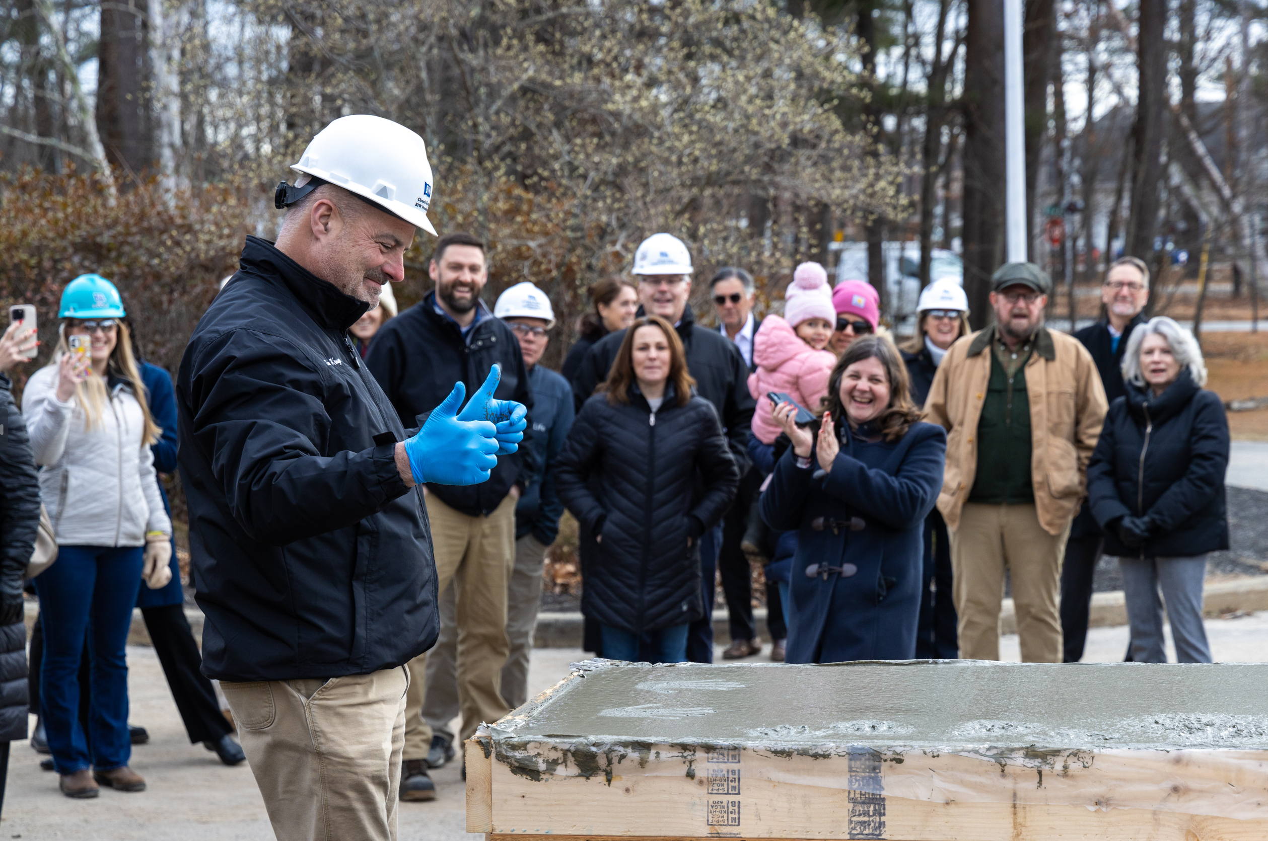 Krugh gives a thumbs up while others look on.