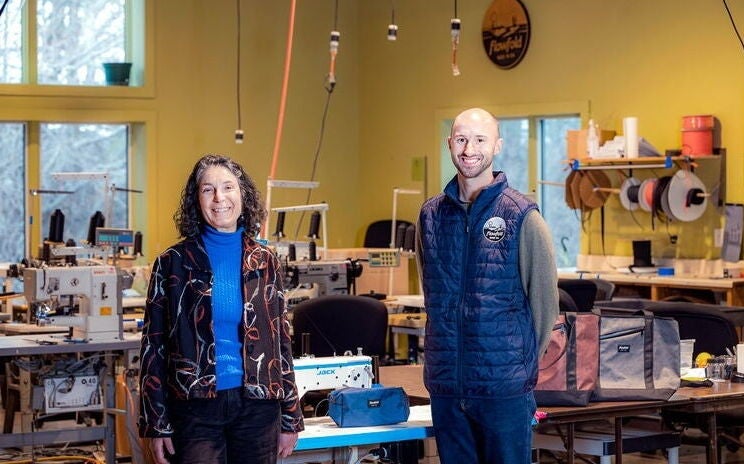 Representatives from MERIT and Flowfold meet at the Flowfold shop.