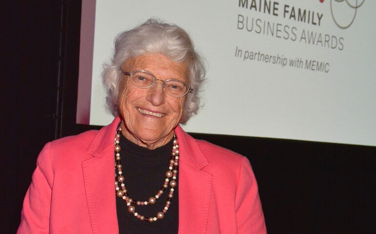 Madddy Corson holding an award