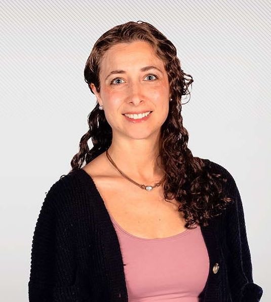 A person poses for a headshot.