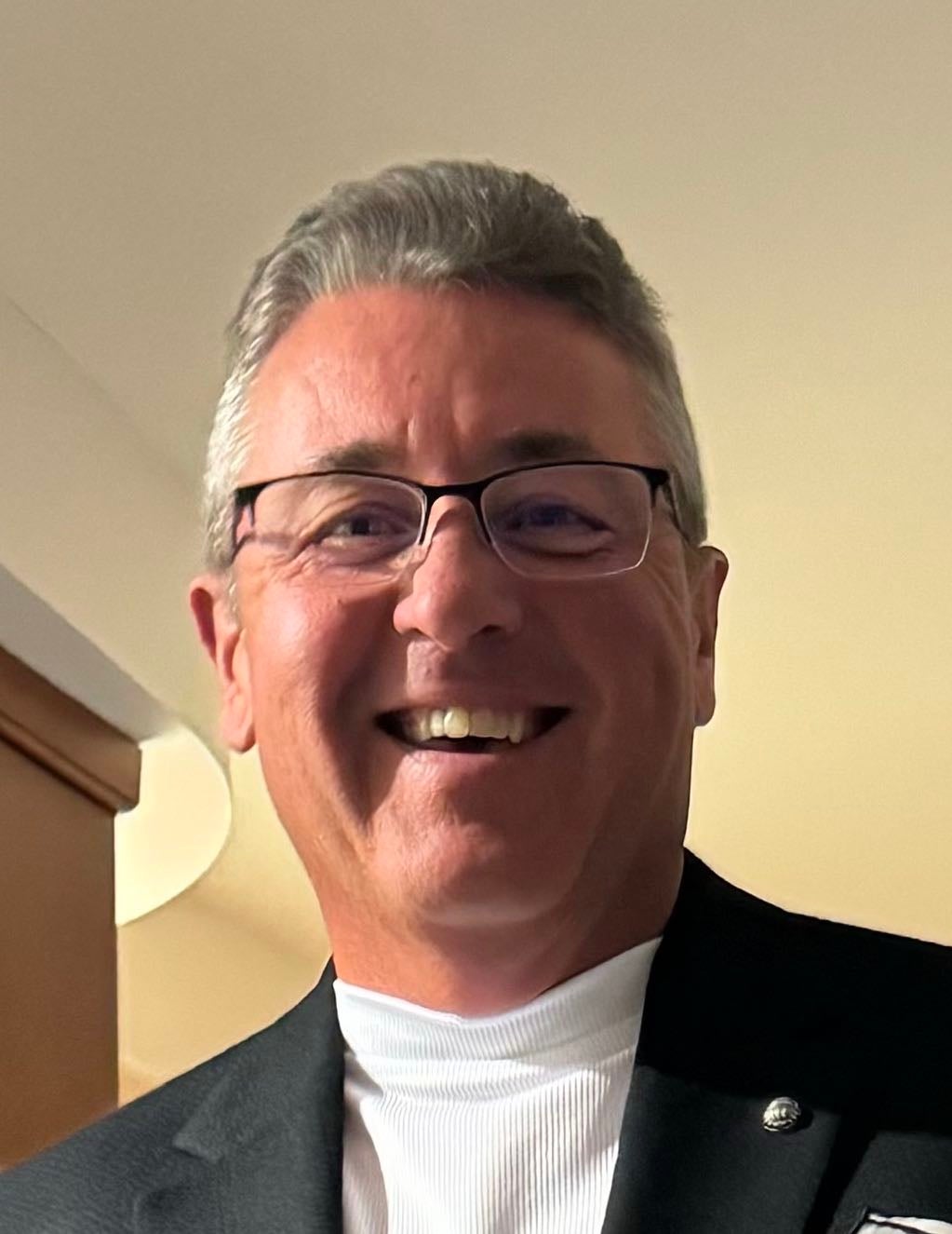 A person poses for a headshot.