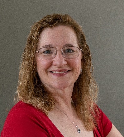 person in red dress smiling