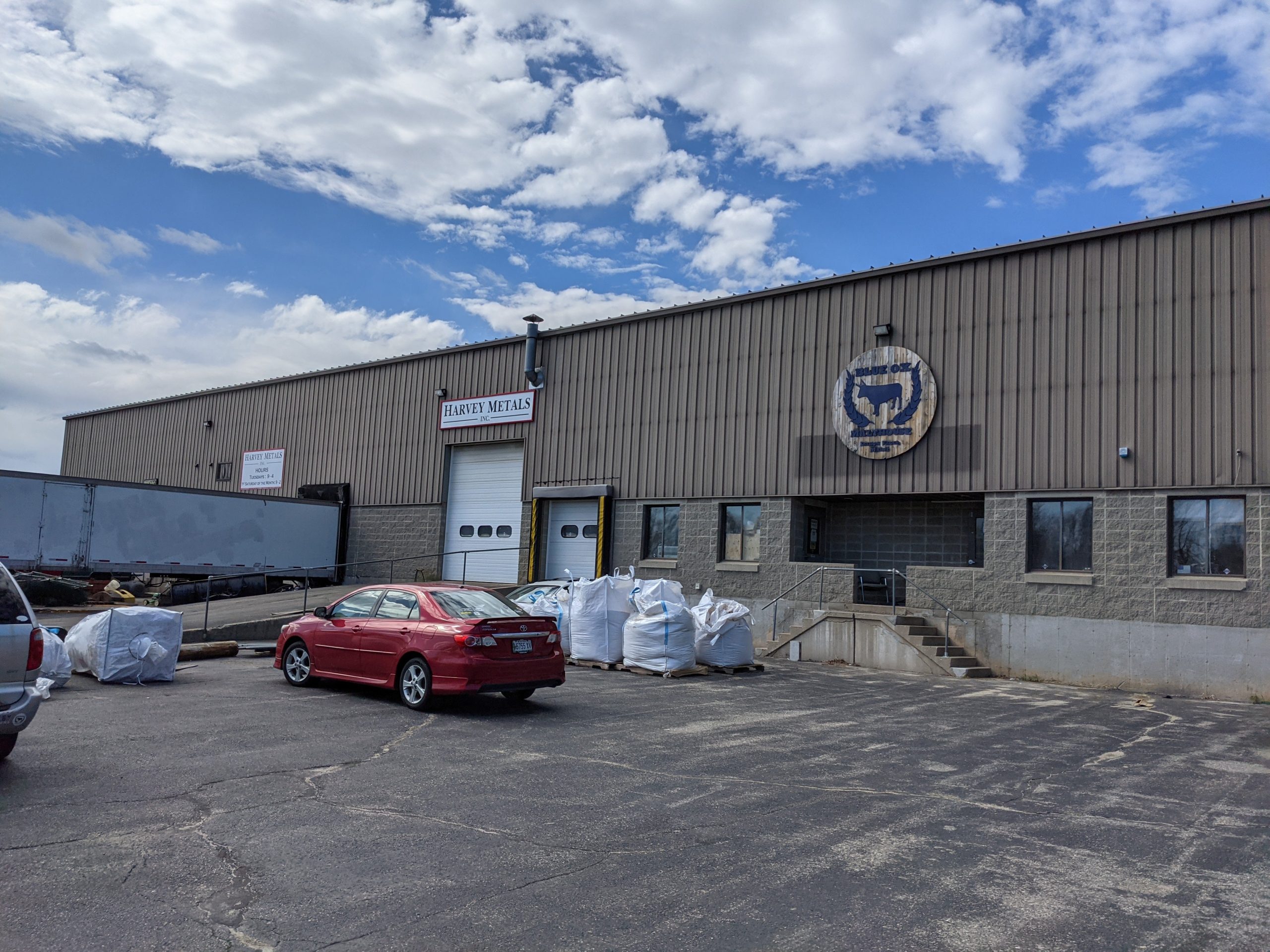 metal building with car and bags
