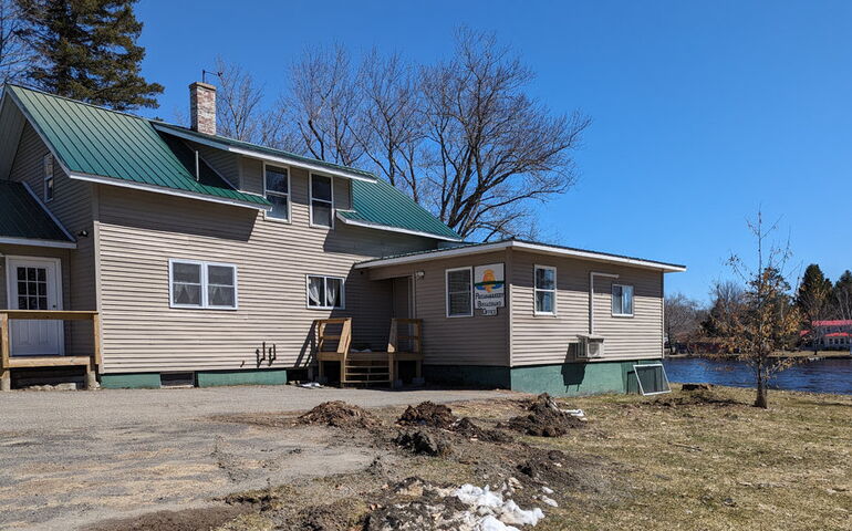 A small buliding with a small lawn.