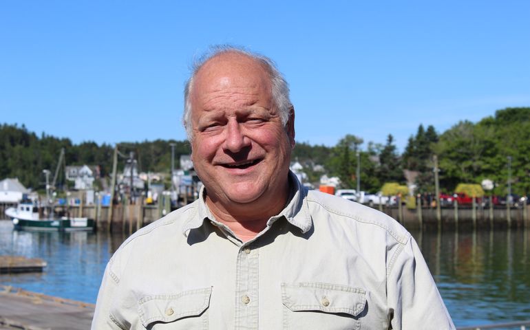 person smiling on shorefront