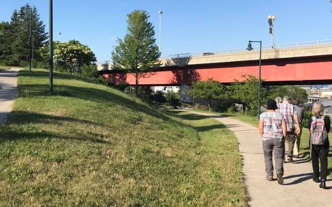 People walk on a sidewalk in Portland.