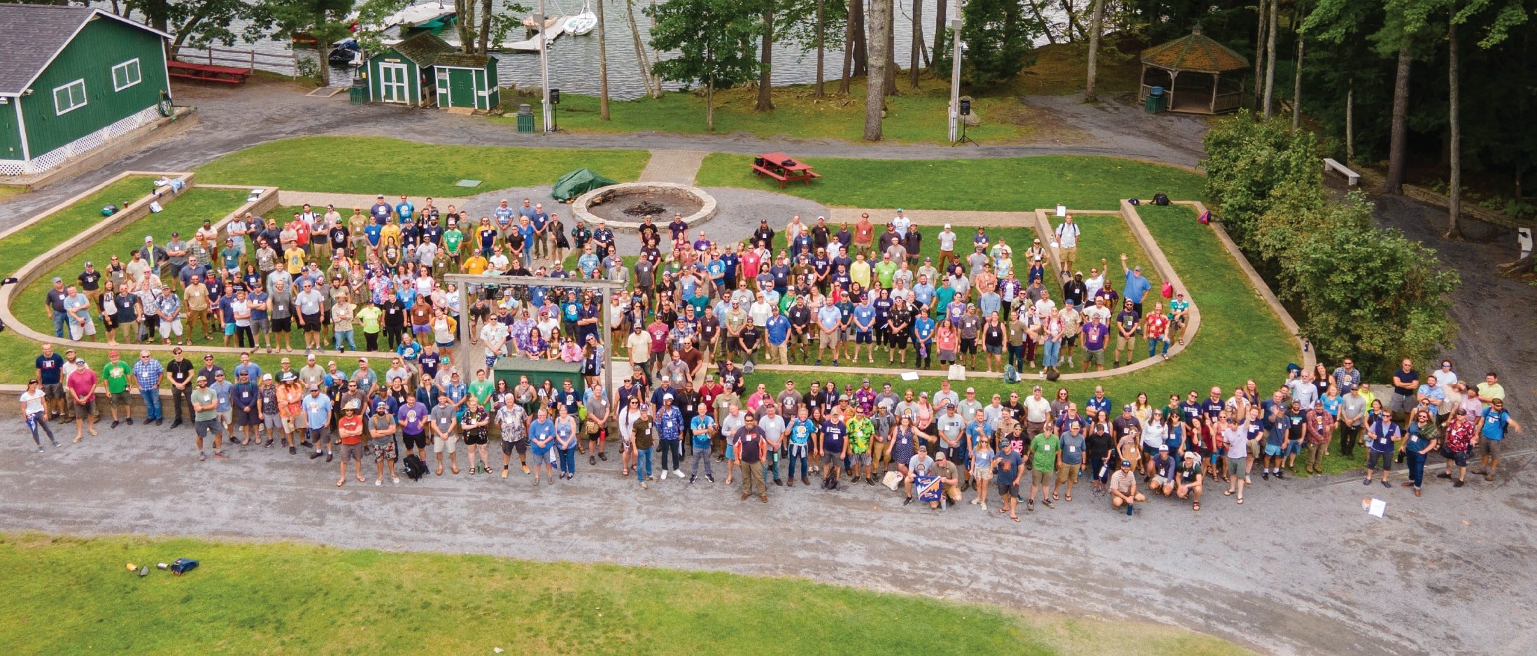 aerial of crowd of people on lawn and driveway