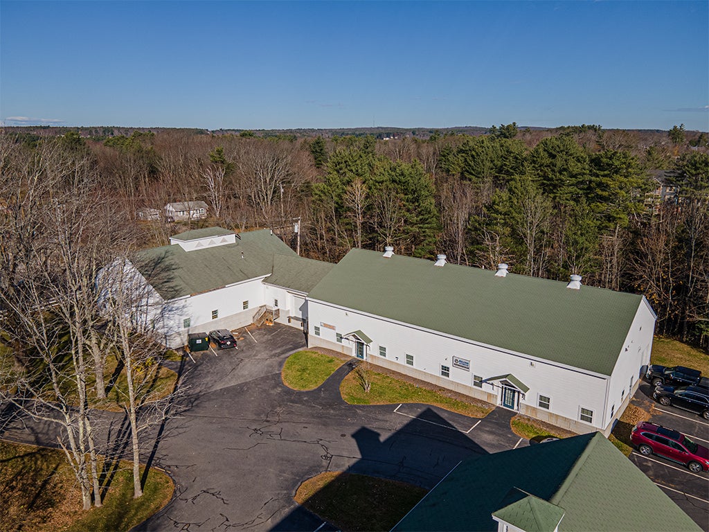 aerial view of white buildings and parking lot