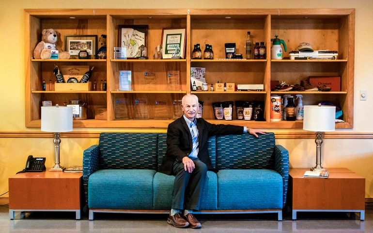 Carlos Mello seated on a couch