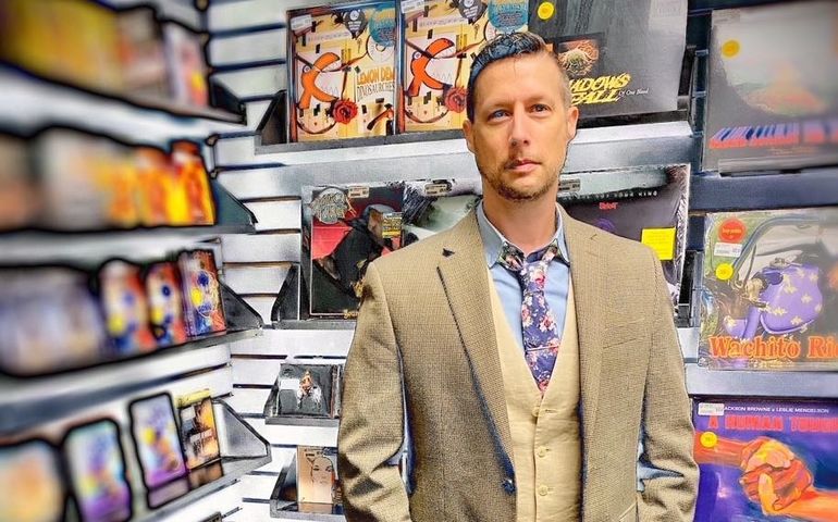 person with records on shelves
