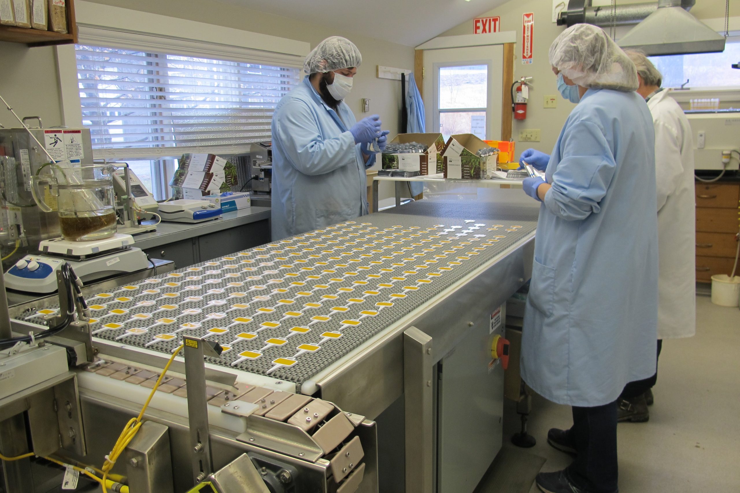 three people at lab workbench